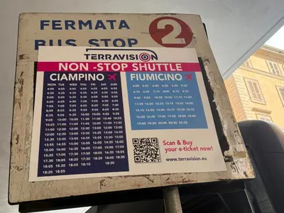 a sign for a bus stop with a bus at sweety rome in Rome