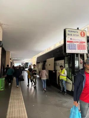 a group of people walking outside of a bus at sweety rome in Rome