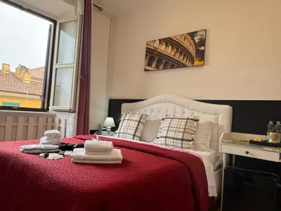 a bedroom with a bed with a red blanket at sweety rome in Rome