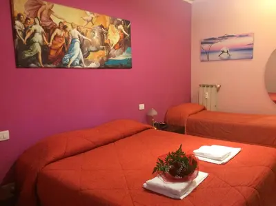 a room with two beds and a painting on the wall at Alenic in Rome
