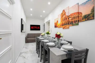 a long dining room with a long table and chairs at Picorini House in Rome