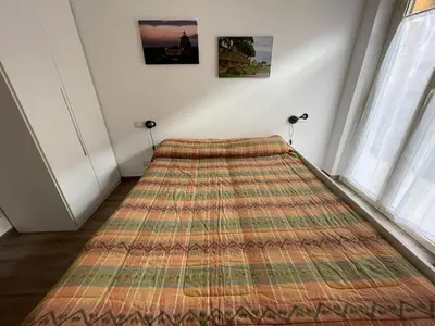 a bed in a room with a large rug on the floor at Comfort a 7 fermate dal Colosseo in Rome