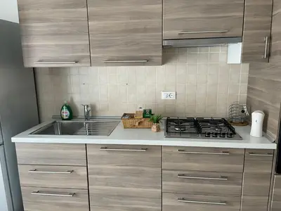 a kitchen with a sink and a stove at Comfort a 7 fermate dal Colosseo in Rome