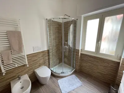 a bathroom with a shower and a toilet and a sink at Comfort a 7 fermate dal Colosseo in Rome