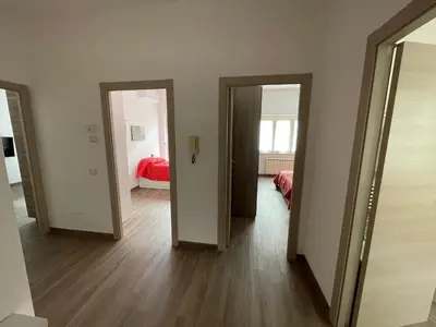 a hallway with three open doors and a bedroom at Comfort a 7 fermate dal Colosseo in Rome