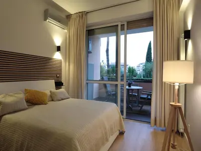 a bedroom with a bed and a sliding glass door at Vatican City Green Apartment in Rome