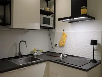 a kitchen with a sink and a microwave at Vatican City Green Apartment in Rome