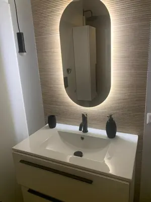 a bathroom with a white sink and a mirror at Vatican City Green Apartment in Rome