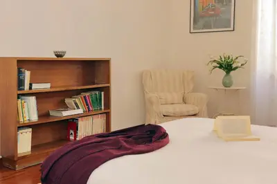 a bedroom with a bed and a book shelf at FM Apartment in Rome