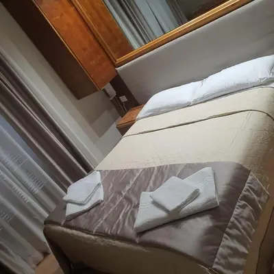 a hotel room with a bed with a red blanket at Affittacamere REGIO in Rome