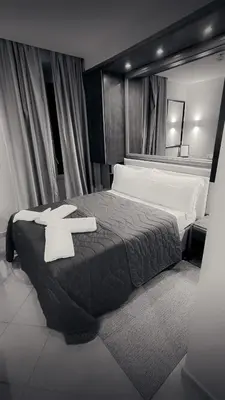 a bedroom with a red bed and a mirror at Affittacamere REGIO in Rome