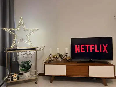 a living room with a tv and a netflix sign at Stella Luxury House in Rome