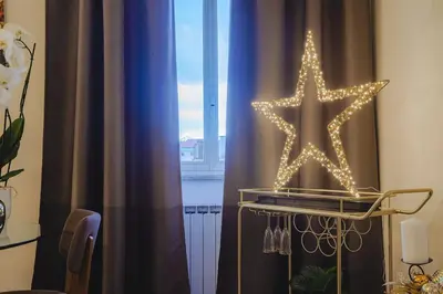 a star on a curtain in front of a window at Stella Luxury House in Rome