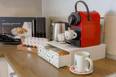a kitchen with a counter with cups and a coffee maker at Stella Luxury House in Rome