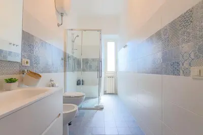 a bathroom with a tub and a toilet and a sink at Stella Luxury House in Rome