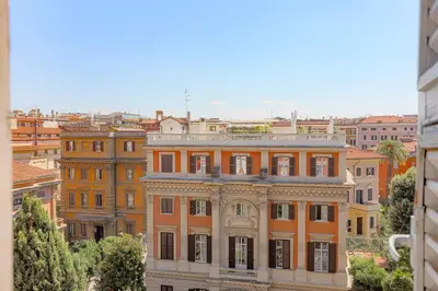a large orange building in the middle of a city at Stella Luxury House in Rome