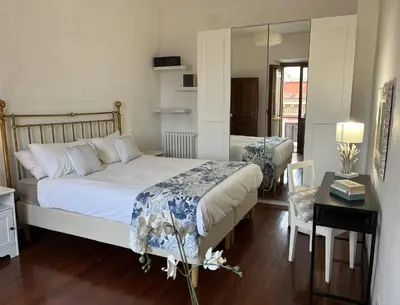 a bedroom with a bed and a table and a mirror at portapia in Rome