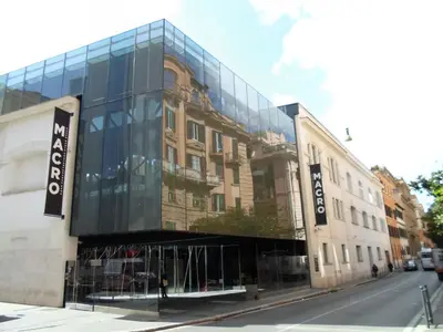 a large glass building on the side of a street at portapia in Rome