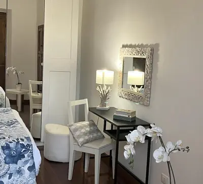 a bedroom with a desk and a mirror and a bed at portapia in Rome
