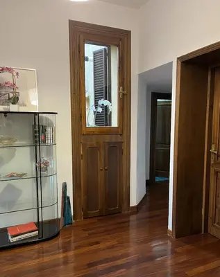 a room with a wooden door and a glass cabinet at portapia in Rome
