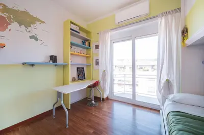 a bedroom with a desk and a window at Tiber House 60 Rome Marconi - Rome Vacation M&D in Rome