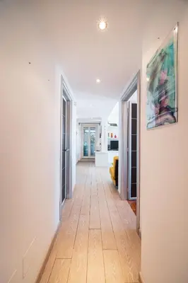 a hallway with white walls and a hard wood floor at Tiber House 60 Rome Marconi - Rome Vacation M&D in Rome