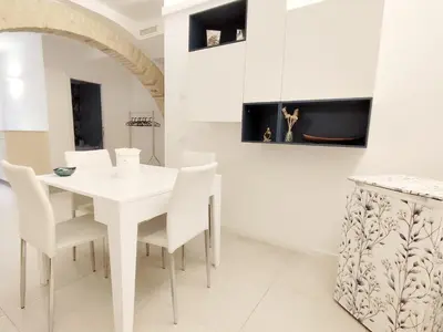 a white dining room with a white table and chairs at Alessandro Luxury Home Rome in Rome