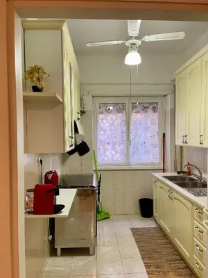 a kitchen with a sink and a window with curtains at MySweetHome near the Vatican in Rome