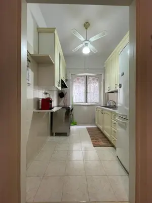 a kitchen with white appliances and a ceiling fan at MySweetHome near the Vatican in Rome