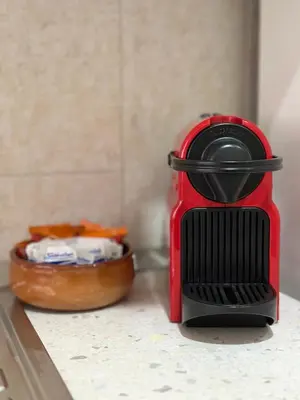 a red blender sitting on a counter with a bowl of food at MySweetHome near the Vatican in Rome
