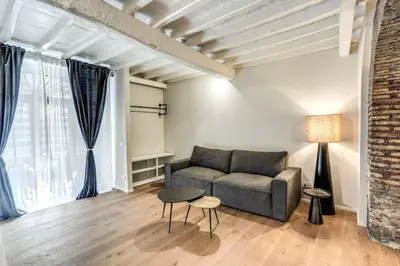 a living room with a couch and a table at Suite Orsoline Spanish steps in Rome