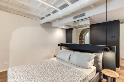 a bedroom with a bed and a mirror at Suite Orsoline Spanish steps in Rome