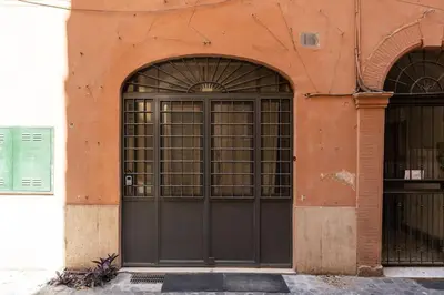 an orange building with a large black door at Suite Orsoline Spanish steps in Rome