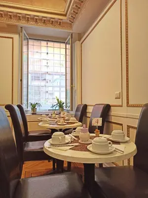 a conference room with tables and chairs and a window at Domina Popolo in Rome