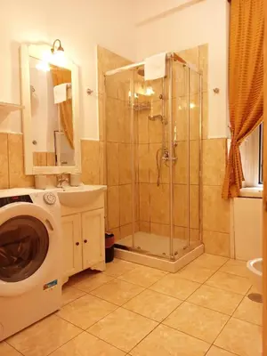a bathroom with a shower and a washing machine at Domina Popolo in Rome
