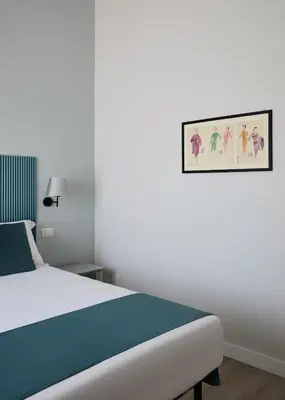 a bedroom with a bed and a picture on the wall at Domus Modista (Musei Vaticani) in Rome