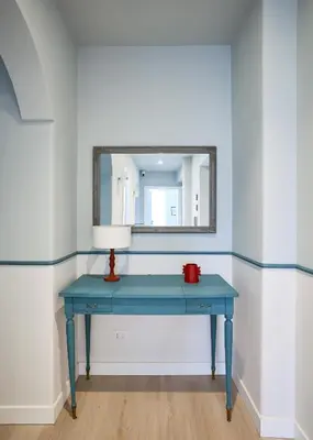a blue table with a mirror and a red lamp at Domus Modista (Musei Vaticani) in Rome