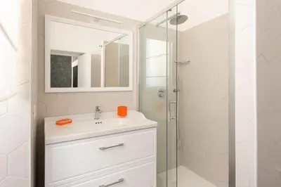 a white bathroom with a sink and a shower at Retro Flat Termini in Rome