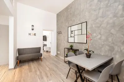 a dining room with a table and chairs at Retro Flat Termini in Rome