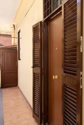 a room with two doors and a hallway with a floor at Retro Flat Termini in Rome