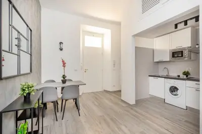 a kitchen and dining room with a table and chairs at Retro Flat Termini in Rome