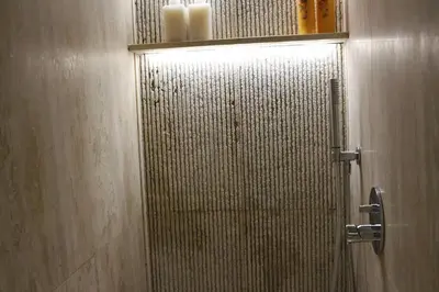 a kitchen with white cabinets and a sink and a counter at Trevi Fountain Luxury Flat in Rome