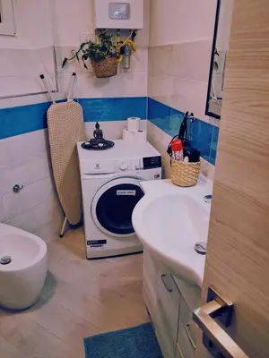 a small bathroom with a microwave and a sink at Lovers' Nest - Spa Apartment in Rome