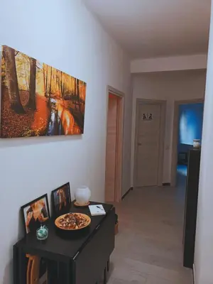 a living room with a pizza on a table at Lovers' Nest - Spa Apartment in Rome