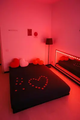 a bedroom with a black bed with red lighting at Lovers' Nest - Spa Apartment in Rome