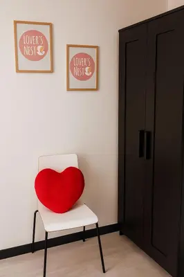 a red heart pillow on a chair in a room at Lovers' Nest - Spa Apartment in Rome