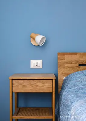a bedroom with a bed and a nightstand with a light at Domus Alberico 11 (Vaticano) in Rome