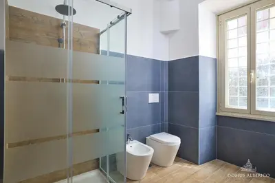 a bathroom with a toilet and a glass shower at Domus Alberico 11 (Vaticano) in Rome