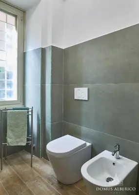 a bathroom with a toilet and a sink at Domus Alberico 11 (Vaticano) in Rome