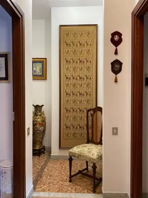 a hallway with a chair and a door with a clock at Semini di nostalgia in Rome